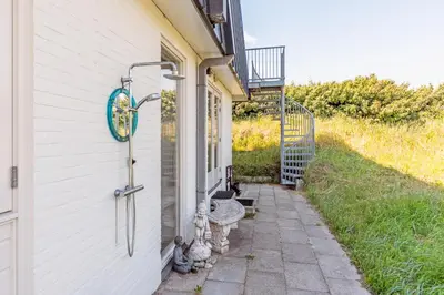 a building with a sign on the side of it at Beach house Alba in Bergen aan Zee