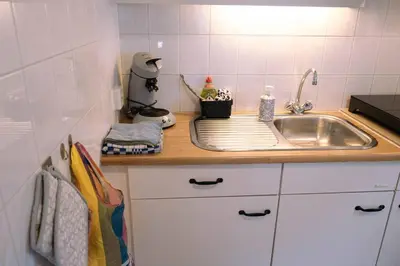 a kitchen with a sink and a counter top at 'T Heilige Pad in Egmond aan Zee