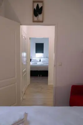 a room with a bedroom with a bed and a mirror at 'T Heilige Pad in Egmond aan Zee