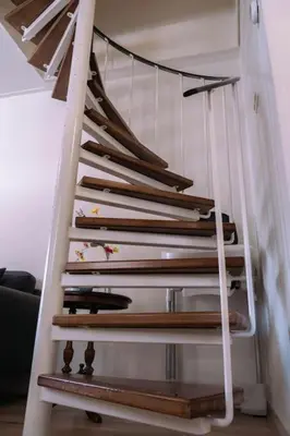 a white staircase with wooden risers in a room at 'T Heilige Pad in Egmond aan Zee