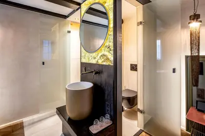 a bathroom with a door and a mirror at Mister Highland Hotel in Amsterdam