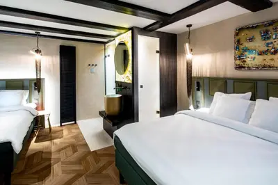 a hotel room with two beds and a bathroom at Mister Highland Hotel in Amsterdam
