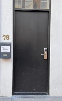 a black door with a sign in front of it at Hotel Bellington in Amsterdam