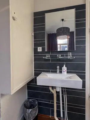 a bathroom with a sink and a mirror at Hotel Bellington in Amsterdam