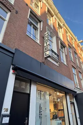 a store front of a brick building at Hotel Bellington in Amsterdam