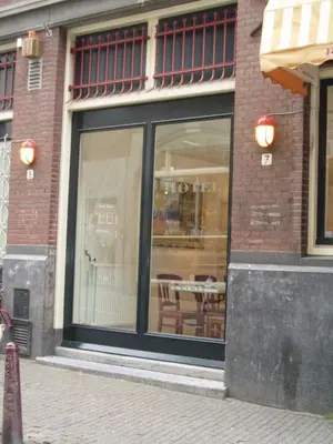 a building with a window with a table in it at Rho Hotel in Amsterdam
