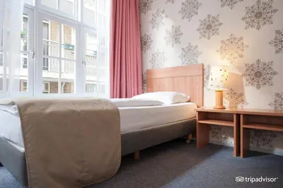 a bedroom with a bed and a window at Rho Hotel in Amsterdam
