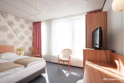 a bedroom with a bed and a flat screen tv at Rho Hotel in Amsterdam