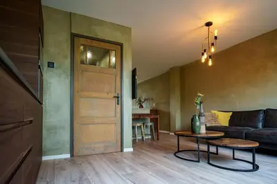 a living room with a couch and a table and a door at City Design Studio in Alkmaar