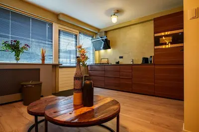 a living room with a table and a kitchen at City Design Studio in Alkmaar