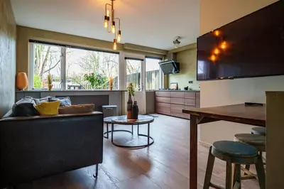 a kitchen and living room with a couch and a table at City Design Studio in Alkmaar