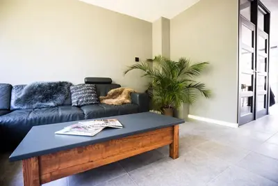 a living room with a couch and a coffee table at CityHouse Alkmaar in Alkmaar