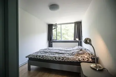 a bedroom with a bed and a window at CityHouse Alkmaar in Alkmaar