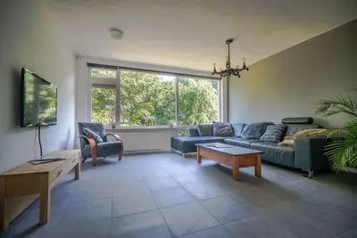 a living room with a couch and a table at CityHouse Alkmaar in Alkmaar