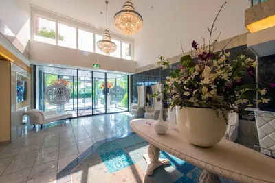 a lobby with a table with flowers on it at Grand Hotel Amstelveen in Amstelveen