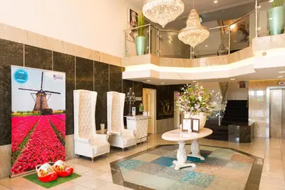 a lobby with a display of flowers and a windmill at Grand Hotel Amstelveen in Amstelveen