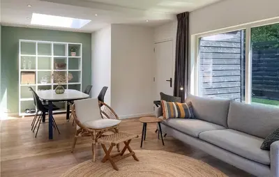 a living room with a couch and a table at Stunning Home In Noordwijk With Wifi in Noordwijk aan Zee