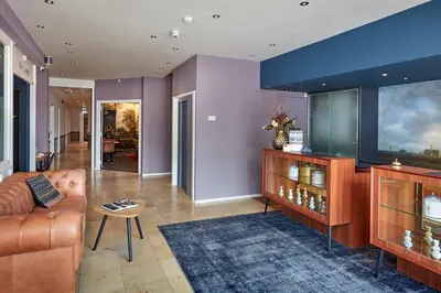 a living room with a couch and a table at Hotel Lion D'Or in Haarlem