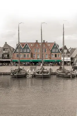 a group of boats docked in a harbor with buildings at Hotel Old Dutch in Volendam