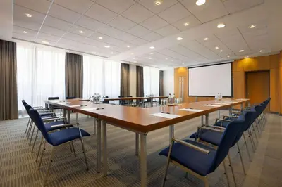a large conference room with a long table and chairs at Ramada by Wyndham Amsterdam Airport Schiphol in Badhoevedorp