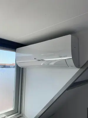 a room with a window and a white microwave at Guesthouse Katwijk aan Zee in Katwijk aan Zee
