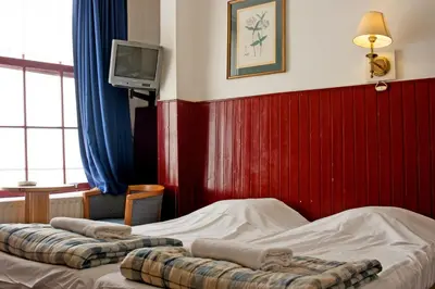 a hotel room with two beds and a tv at De Mallemoolen in Amsterdam