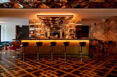 a bar in a restaurant with stools at Park Centraal Amsterdam, part of Sircle Collection in Amsterdam