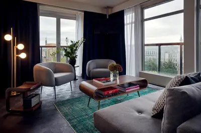 a living room with a couch and a table at Park Centraal Amsterdam, part of Sircle Collection in Amsterdam