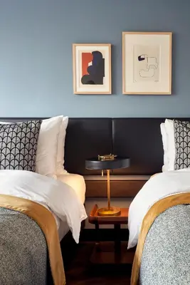 a bedroom with two beds and a table between them at Park Centraal Amsterdam, part of Sircle Collection in Amsterdam
