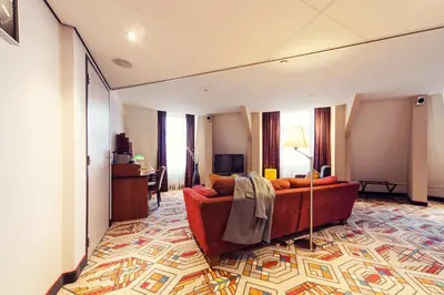 a living room with a red couch in a room at Banks Mansion - Boutique Hotel in Amsterdam