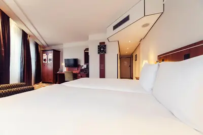 a large white bed in a hotel room at Banks Mansion - Boutique Hotel in Amsterdam