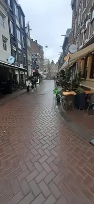 an empty city street with tables and buildings at CHARLOTTE, not for parties, not a hotel, room with shared bathroom, no kitchen in Amsterdam
