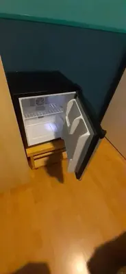 a small refrigerator with its door open in a room at CHARLOTTE, not for parties, not a hotel, room with shared bathroom, no kitchen in Amsterdam