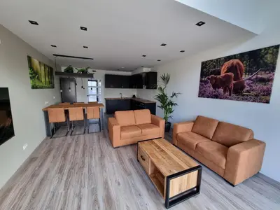 a living room with a couch and a table at DW Castricum in Castricum