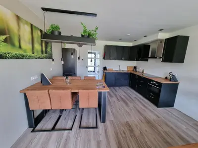 a kitchen with a wooden table in a room at DW Castricum in Castricum