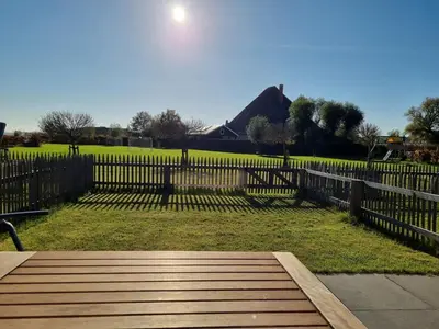 a wooden walkway in front of a fence at DW Castricum in Castricum