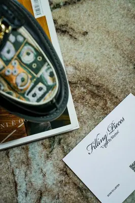 a close up of a purse next to a card at De L’Europe Amsterdam – The Leading Hotels of the World in Amsterdam