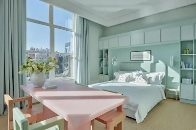 a bedroom with a pink table and a bed at De L’Europe Amsterdam – The Leading Hotels of the World in Amsterdam