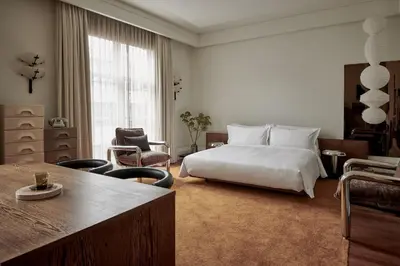 a bedroom with a bed and a table and chairs at De L’Europe Amsterdam – The Leading Hotels of the World in Amsterdam