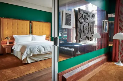 a bedroom with a bed and a green wall at De L’Europe Amsterdam – The Leading Hotels of the World in Amsterdam