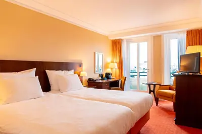 a hotel room with a bed and a television at Van der Valk Palace Hotel Noordwijk in Noordwijk aan Zee