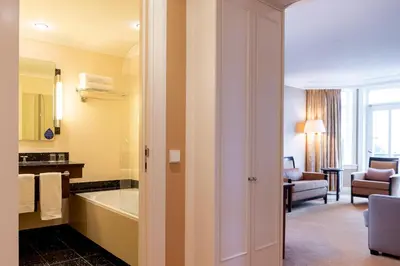 a bathroom with a bath tub and a room at Van der Valk Palace Hotel Noordwijk in Noordwijk aan Zee
