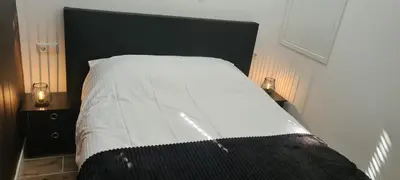 a bedroom with a large bed with a black headboard at The Flower Fields in Lisse