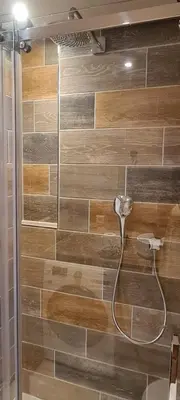 a shower with a hose attached to a wooden wall at The Flower Fields in Lisse