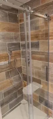 a shower with a glass door in a bathroom at The Flower Fields in Lisse