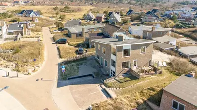 an aerial view of a house in a residential neighborhood at Vernieuwd Zeezicht Villa Duin Suite in Bergen aan Zee