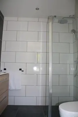 a bathroom with a shower and a toilet at De Bosrand grenzend aan het bos in Castricum