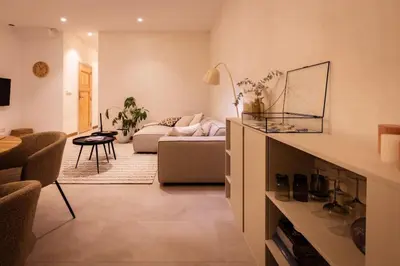 a living room with a couch and a table at Appartement met tuin in Haarlem centrum(Vijfhoek) in Haarlem