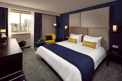 a hotel room with a large bed and a window at Park Plaza Utrecht in Utrecht