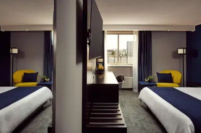 a hotel room with two beds and a window at Park Plaza Utrecht in Utrecht